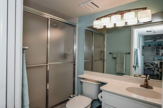 bathroom with vanity, an enclosed shower, and toilet