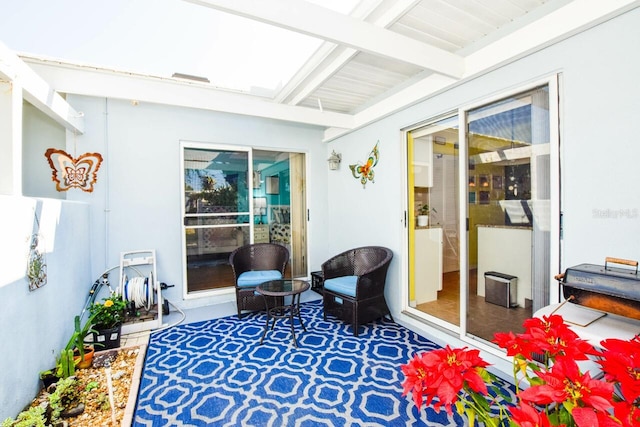 sunroom with beam ceiling