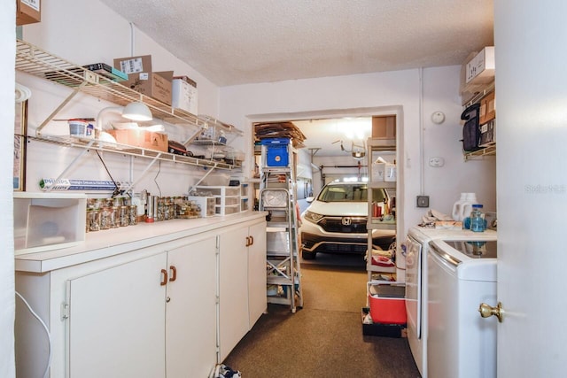 kitchen with white cabinetry, a textured ceiling, and washing machine and clothes dryer