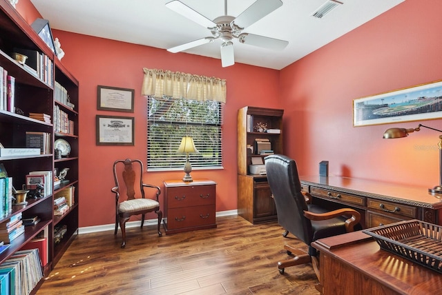 home office with dark hardwood / wood-style floors and ceiling fan