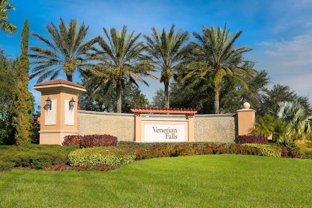 community sign featuring a lawn