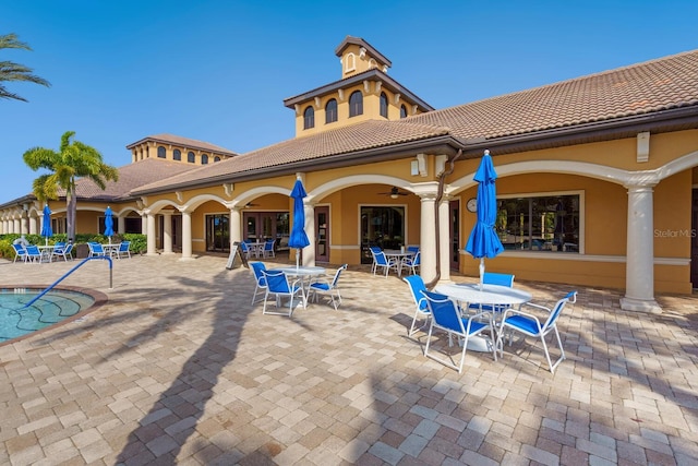 exterior space with ceiling fan and a patio area