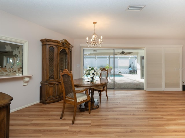 dining area featuring an inviting chandelier and light hardwood / wood-style flooring