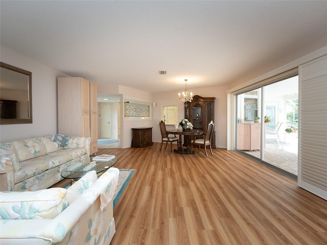 living room featuring light hardwood / wood-style flooring and a chandelier