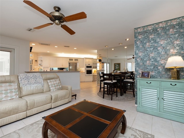 living room featuring light tile patterned floors and ceiling fan