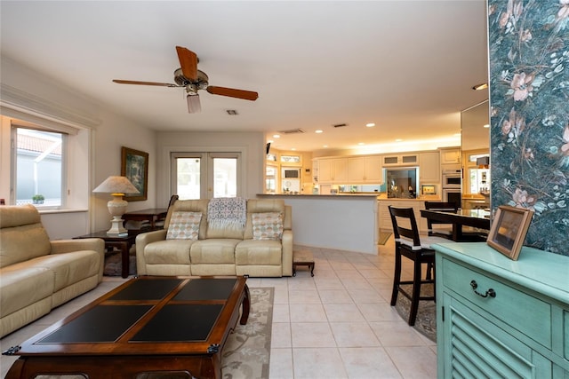 tiled living room featuring french doors, a wealth of natural light, and ceiling fan