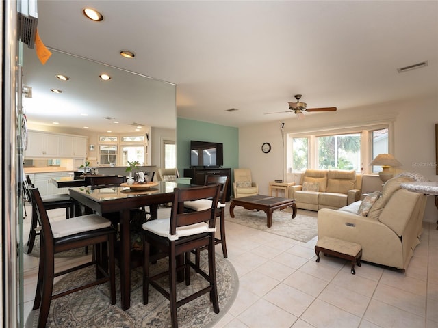 dining space featuring ceiling fan and light tile patterned floors