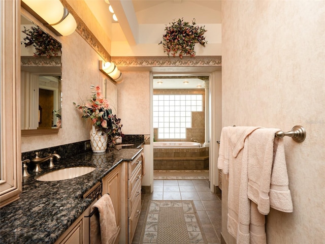 bathroom with vanity, vaulted ceiling, tile patterned floors, and a relaxing tiled tub