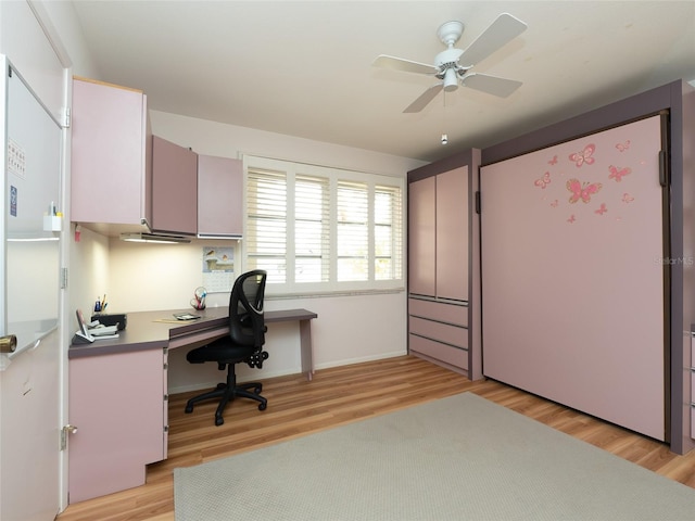 office with light wood-type flooring and ceiling fan