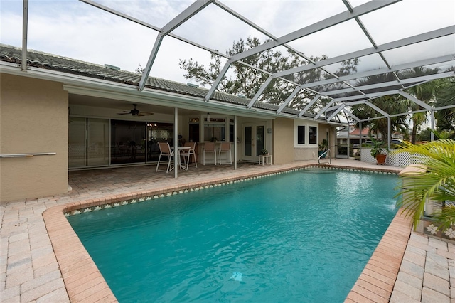 view of swimming pool featuring a lanai, a patio area, ceiling fan, and french doors