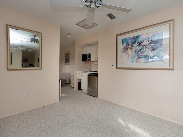 interior space with sink, ceiling fan, and light carpet