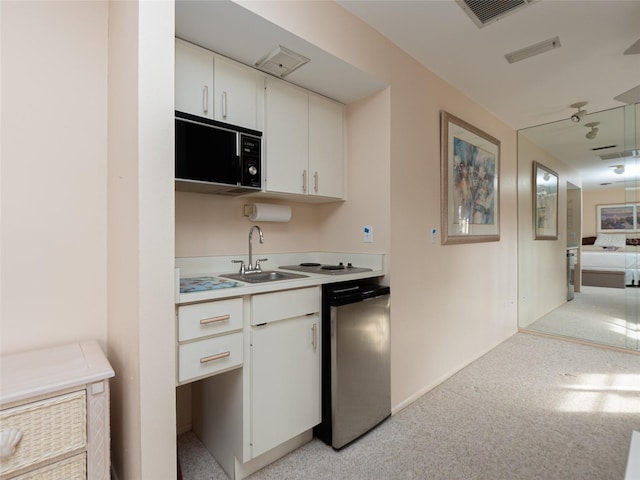 kitchen with sink, white cabinetry, and dishwashing machine