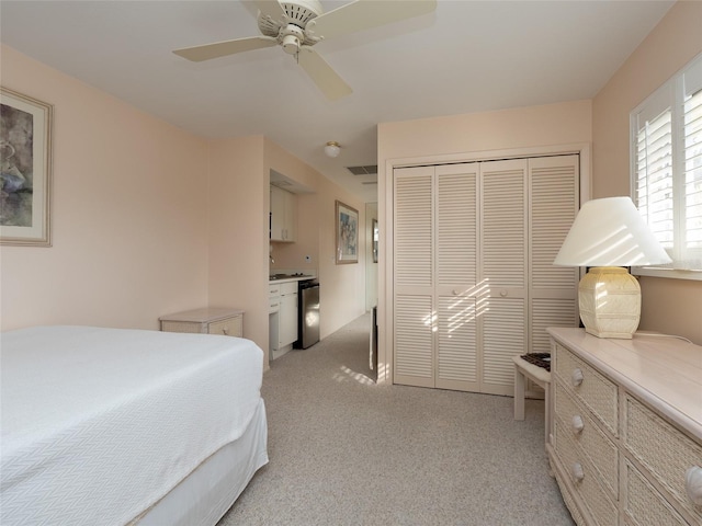 carpeted bedroom featuring a closet and ceiling fan