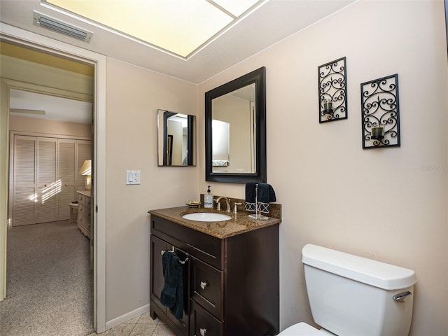 bathroom featuring toilet and vanity