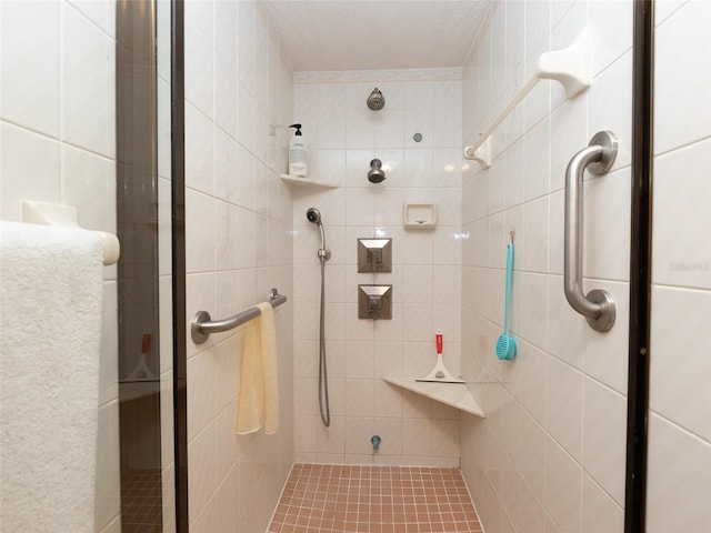 bathroom with tile walls and a tile shower