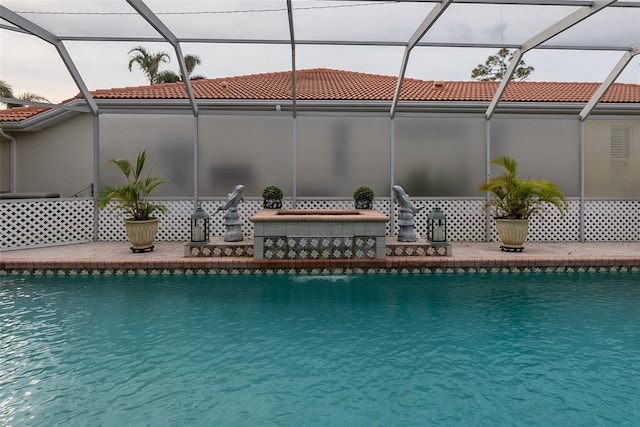 view of swimming pool with glass enclosure