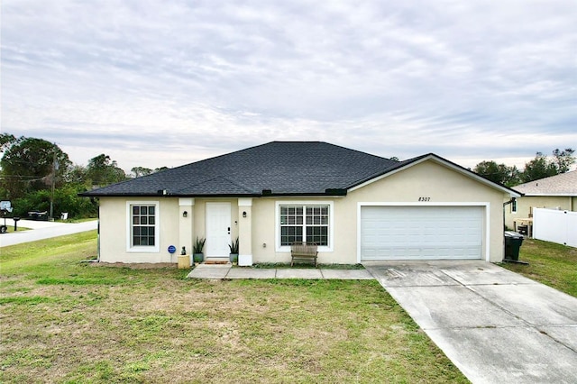 single story home featuring a garage and a front lawn