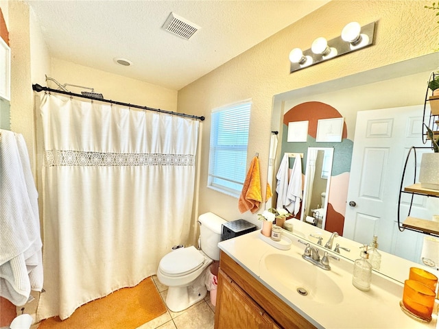 bathroom with curtained shower, a textured ceiling, tile patterned flooring, vanity, and toilet