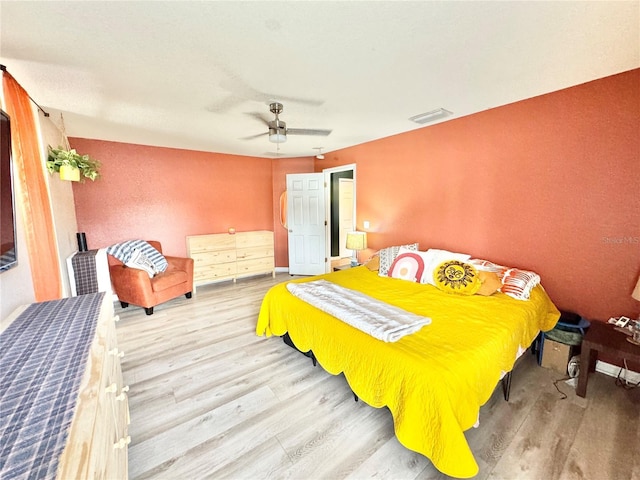 bedroom with ceiling fan and hardwood / wood-style floors