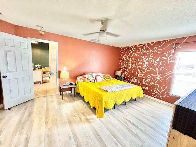 bedroom featuring a textured ceiling, ceiling fan, and wood-type flooring