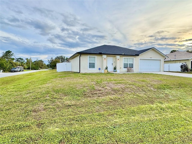 view of front of house with a lawn and a garage