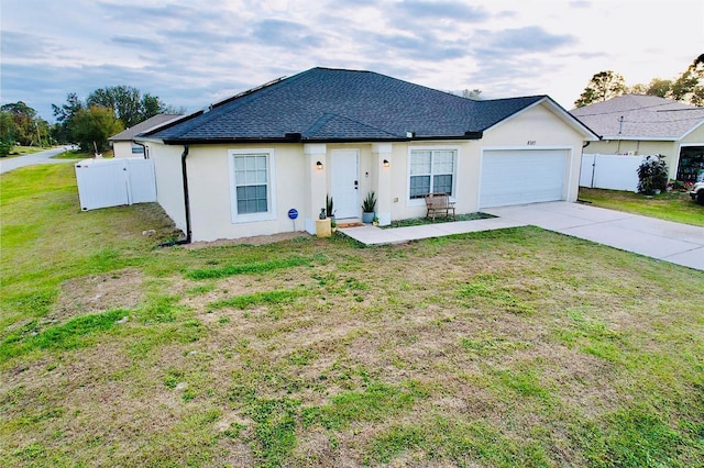 ranch-style house featuring a front yard and a garage