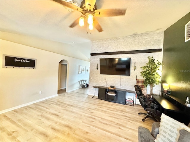 office space with ceiling fan, lofted ceiling, and light wood-type flooring