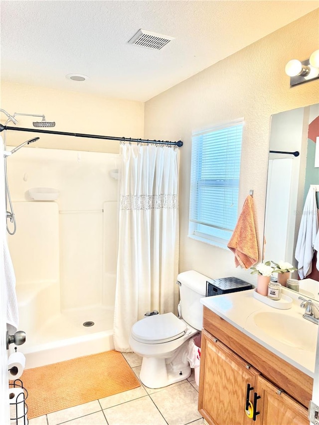 bathroom with toilet, a shower with shower curtain, tile patterned flooring, a textured ceiling, and vanity