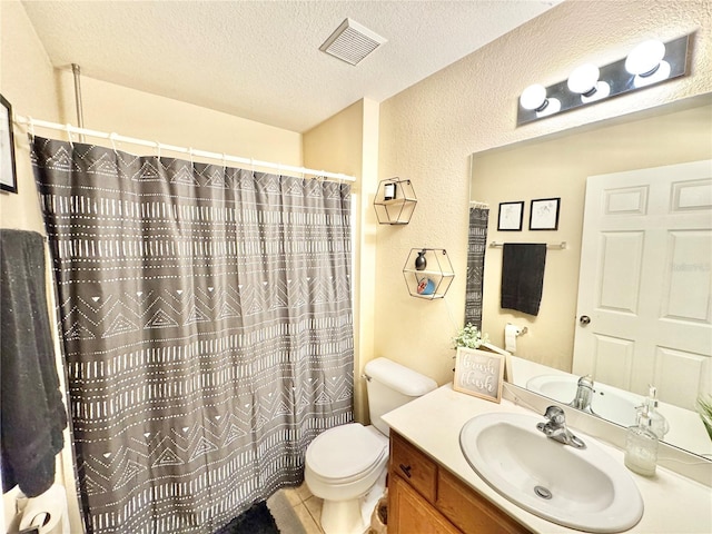 bathroom with toilet, vanity, walk in shower, tile patterned floors, and a textured ceiling