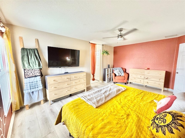 bedroom with ceiling fan and light hardwood / wood-style floors