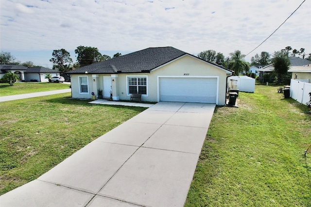 single story home with a garage and a front lawn