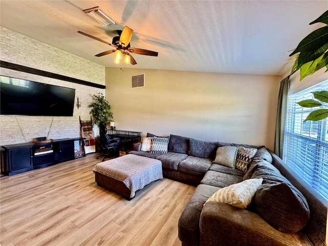 8307 Glover Ave, North Port, FL 34291 - living room featuring ceiling fan, visible vents, a textured ceiling, and wood finished floors