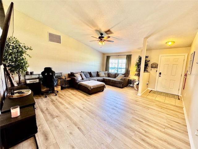 8307 Glover Ave, North Port, FL 34291 - living room with light wood finished floors, visible vents, vaulted ceiling, and a ceiling fan
