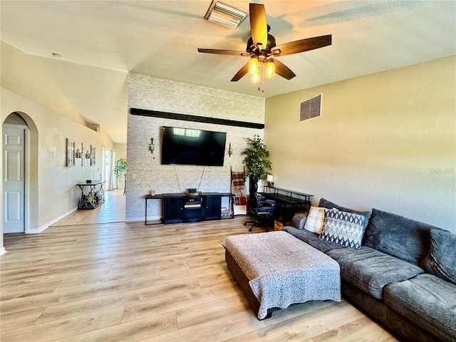 8307 Glover Ave, North Port, FL 34291 - living area featuring a ceiling fan, visible vents, lofted ceiling, arched walkways, and wood finished floors