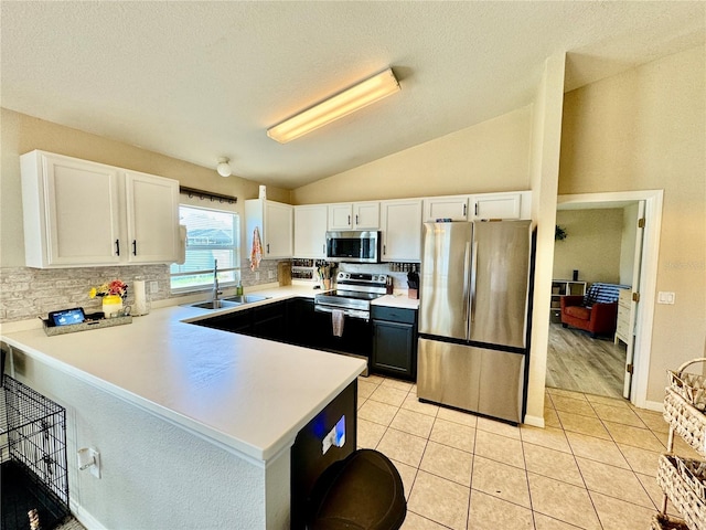 8307 Glover Ave, North Port, FL 34291 - kitchen with a sink, white cabinetry, a peninsula, and stainless steel appliances