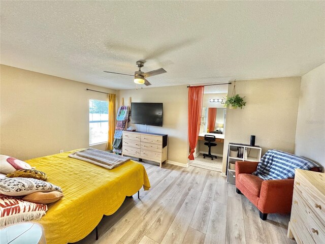8307 Glover Ave, North Port, FL 34291 - bedroom with baseboards, a ceiling fan, light wood-style floors, and a textured ceiling
