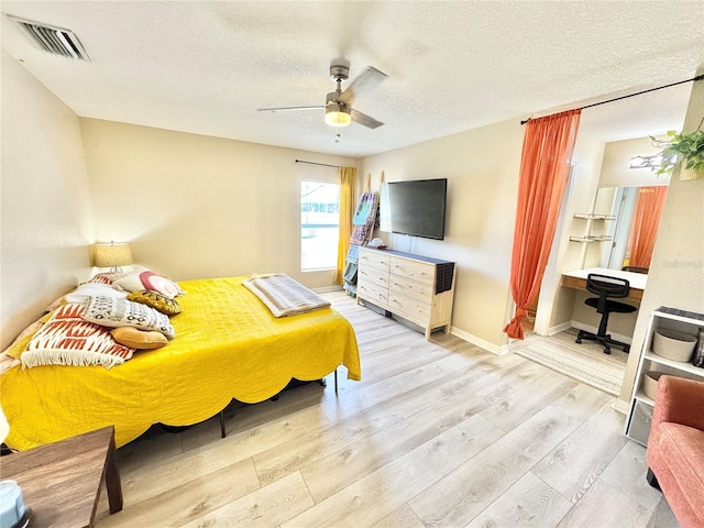 8307 Glover Ave, North Port, FL 34291 - bedroom featuring visible vents, baseboards, ceiling fan, a textured ceiling, and wood finished floors