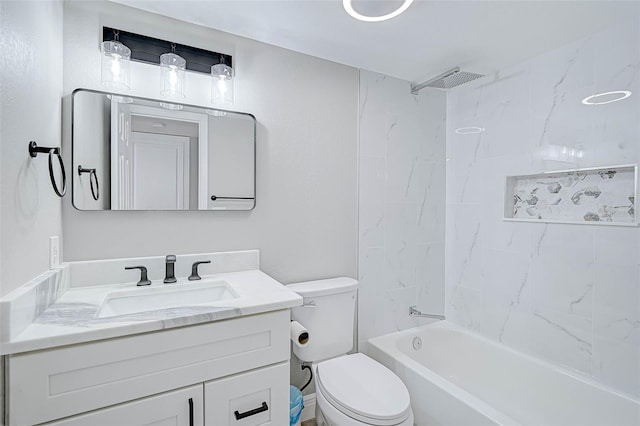 full bathroom with toilet, vanity, and tiled shower / bath