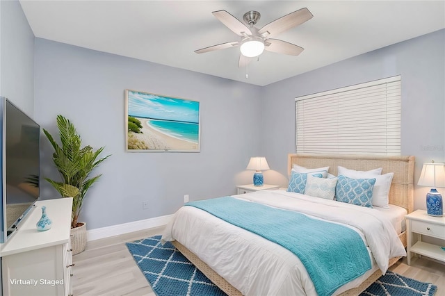 bedroom with ceiling fan and light wood-type flooring