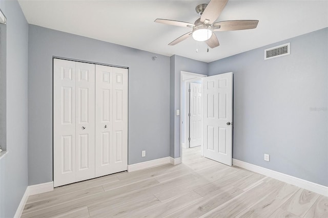 unfurnished bedroom with ceiling fan, a closet, and light hardwood / wood-style floors