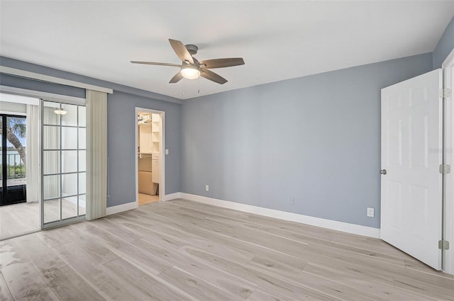 unfurnished bedroom featuring ceiling fan, access to exterior, a closet, and light wood-type flooring