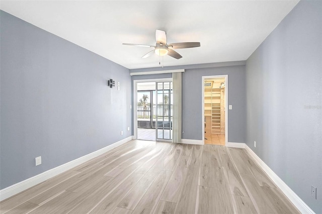 spare room featuring light wood-type flooring and ceiling fan