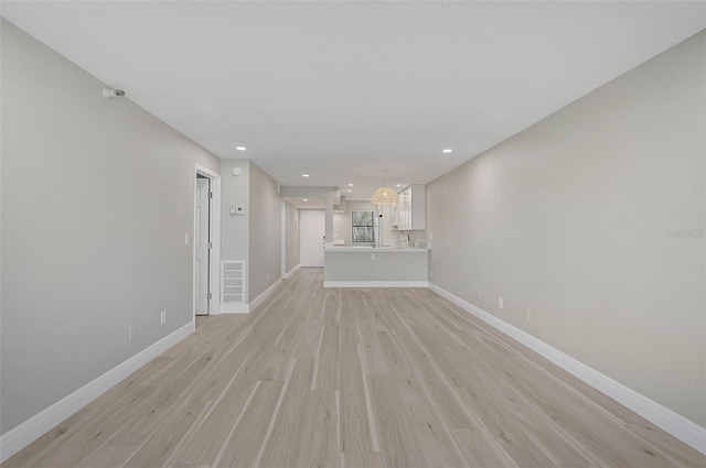 unfurnished living room with light hardwood / wood-style flooring