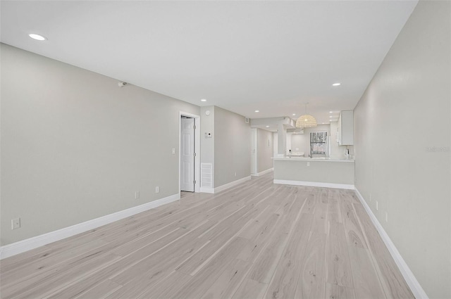 unfurnished living room featuring light hardwood / wood-style floors