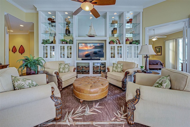 living room with ceiling fan and ornamental molding