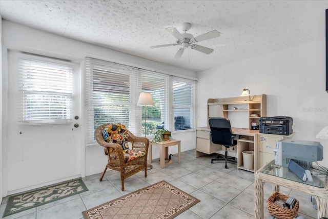 office space featuring light tile patterned flooring, a textured ceiling, and ceiling fan