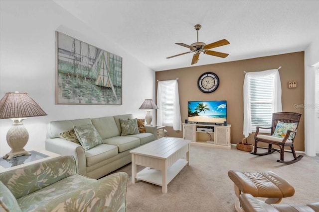 carpeted living room with ceiling fan