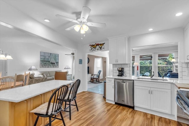 kitchen with sink, stainless steel appliances, and white cabinetry