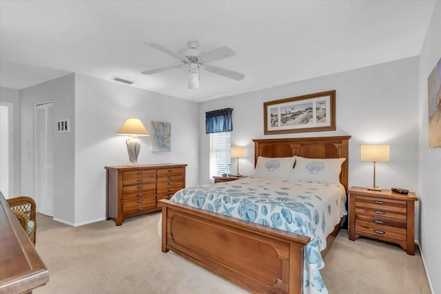 carpeted bedroom with ceiling fan and a closet