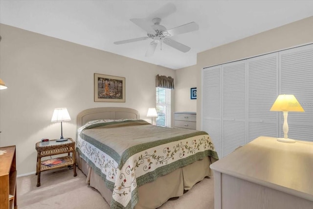 carpeted bedroom with ceiling fan and a closet